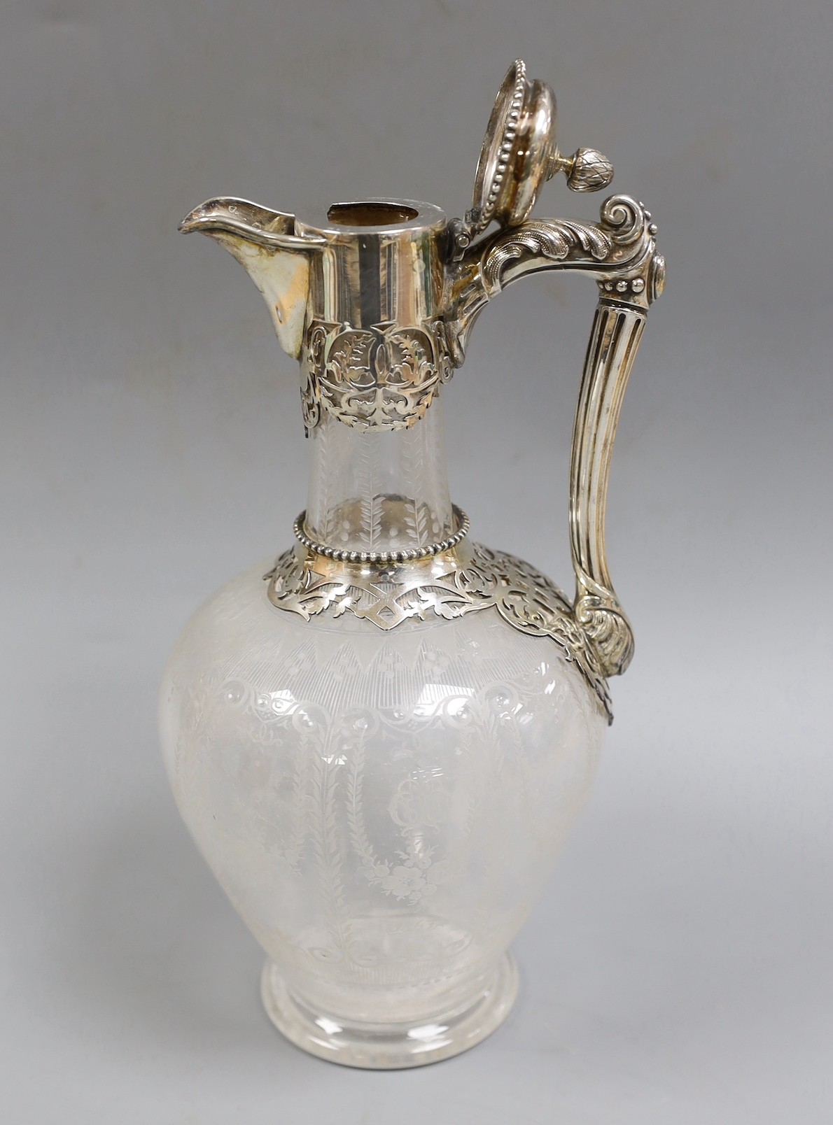 A Victorian silver mounted etched glass claret jug, by W & G Sissons, Sheffield, 1865, the glass with monogram and dated 1867, height 27.4cm.
